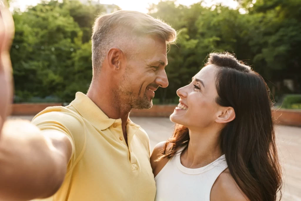 loving couple embrace outdoors in golden sunlight utc