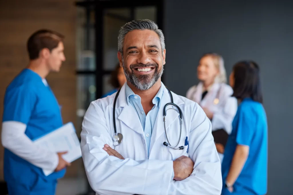 smiling doctor with colleagues in a medical office utc